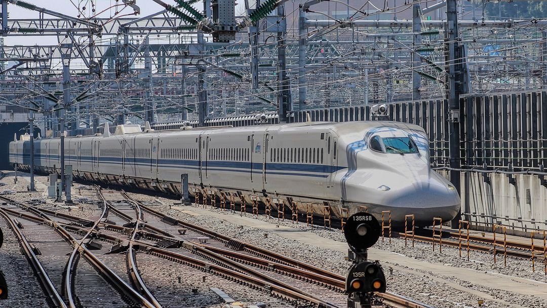 A JR Shinkansen running west, Mount Fuji beyond the line