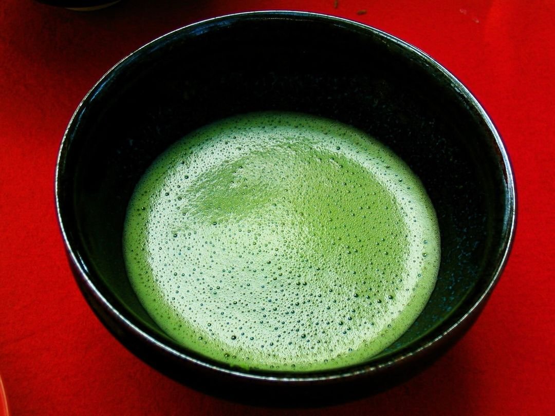 A traditional Japanese tea ceremony, matcha being whisked in a bowl